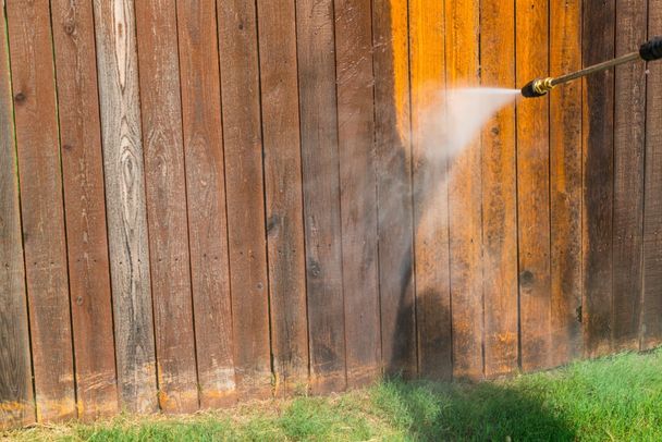 wooden patio porch being pressured washed